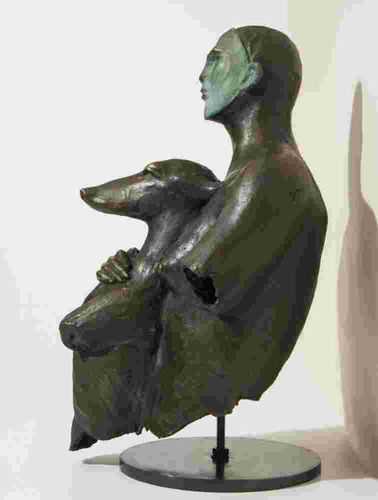 Bronze sculpture of a woman holding a dog