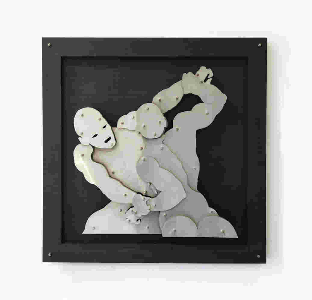 Wall sculpture of two men wrestlers fighting made of steel on black background