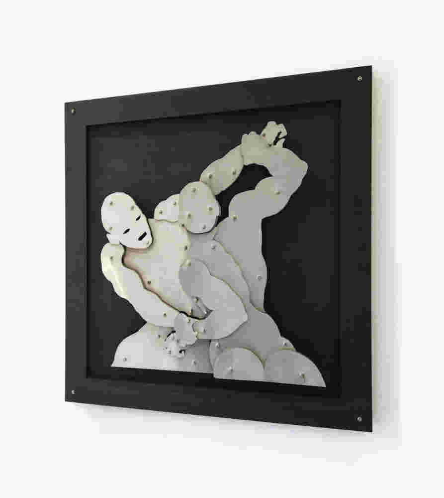 Wall sculpture of two men wrestlers fighting made of steel on black background