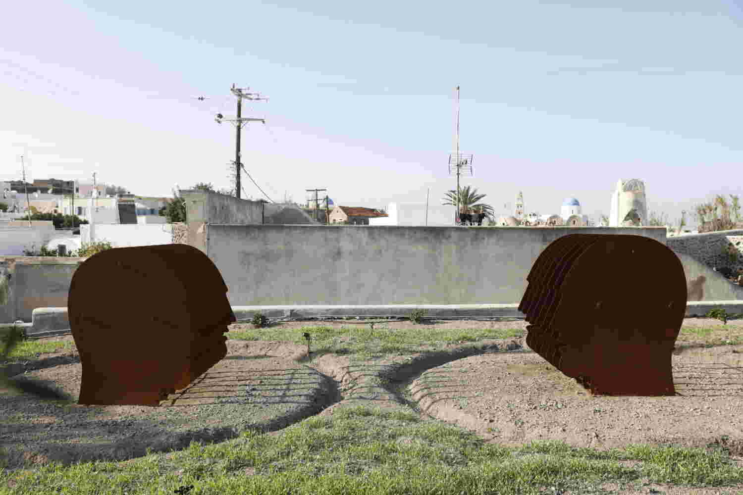 Multiple layers of rusted steel sheets face outdoors sculpture