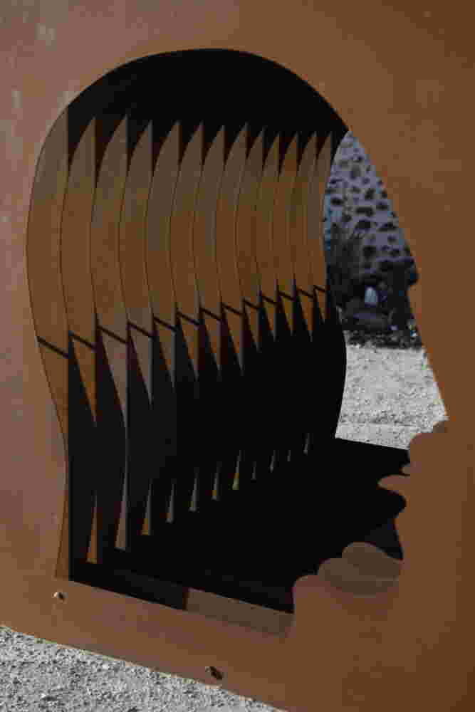 Large-scale exterior art installation – layered face cut-out made from steel.