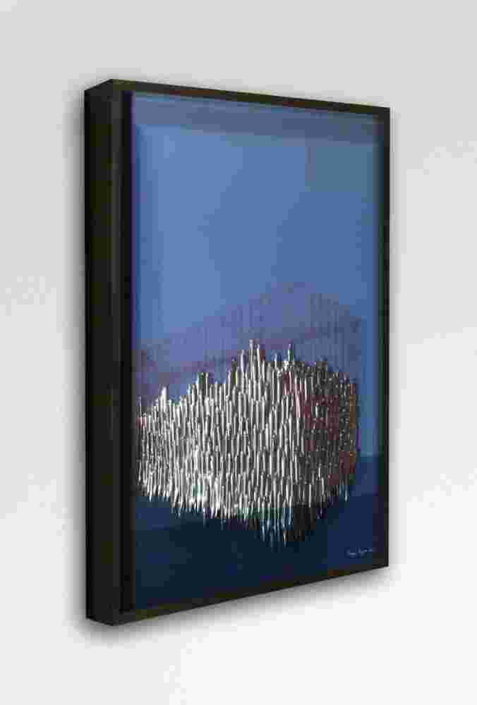 Mixed media wall sculpture of fish being captured in a cage