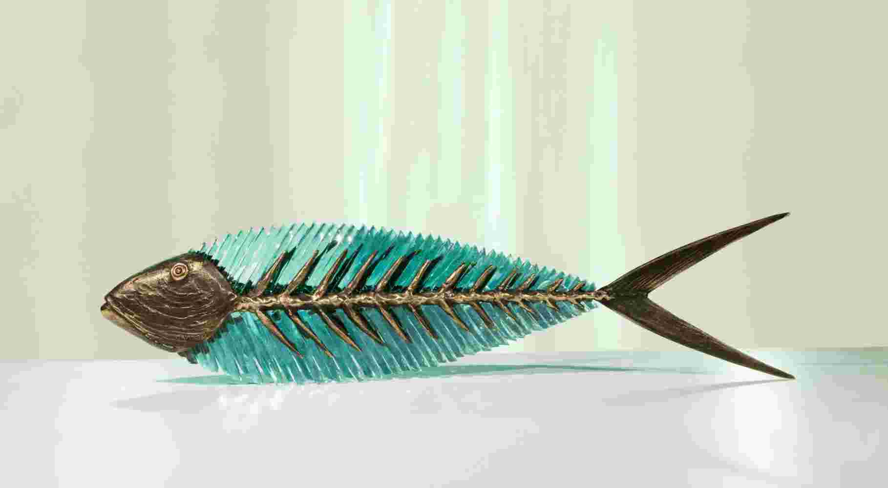 Hand cut glass and bronze sculpture of a fish.