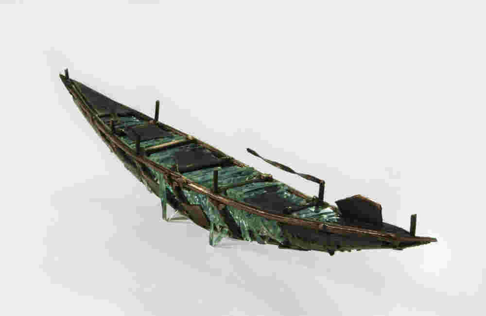 Shipwreck boat sculpture made of hand cut glass and bronze.