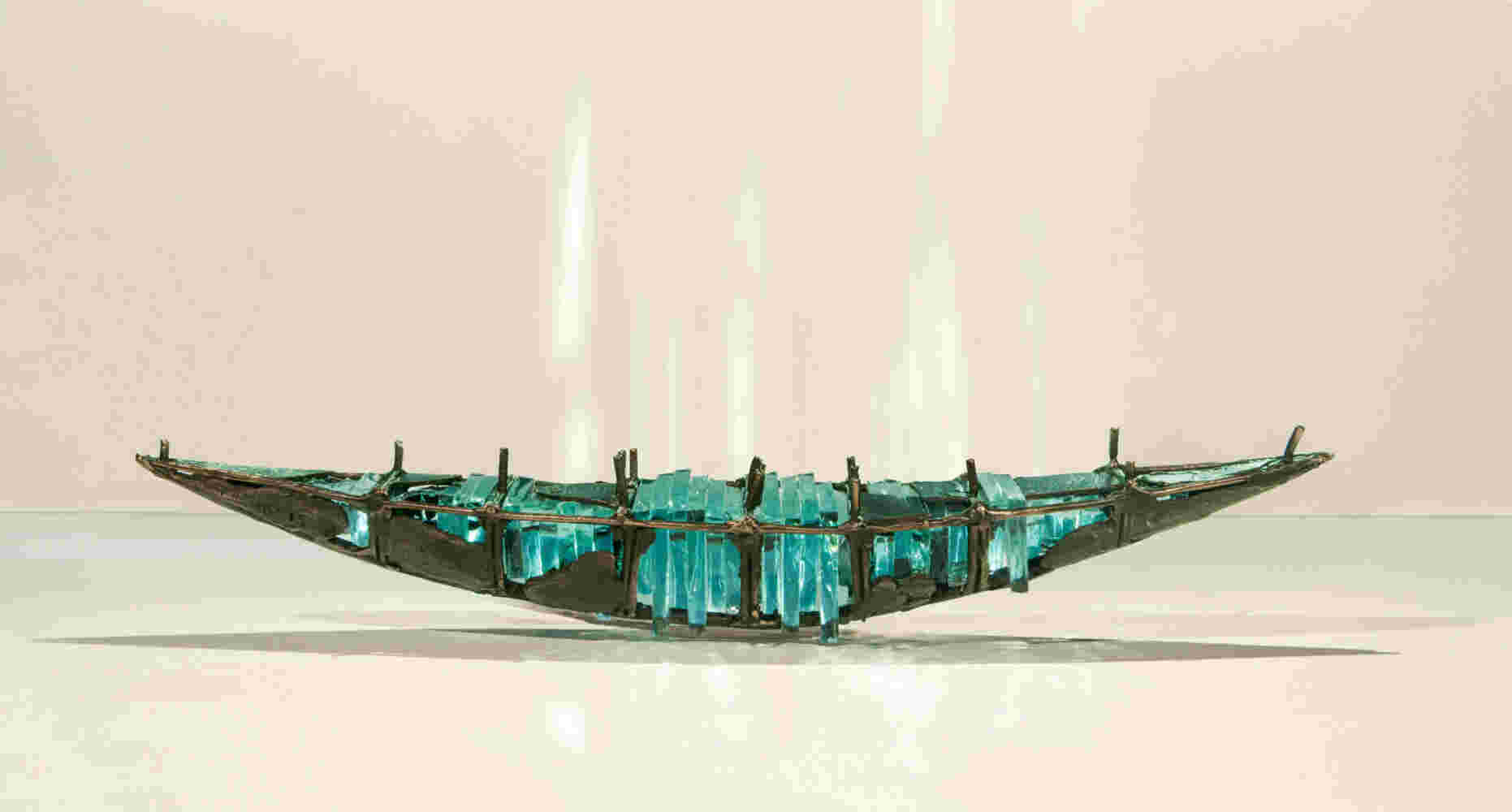 Shipwreck boat sculpture made of hand cut glass and bronze.