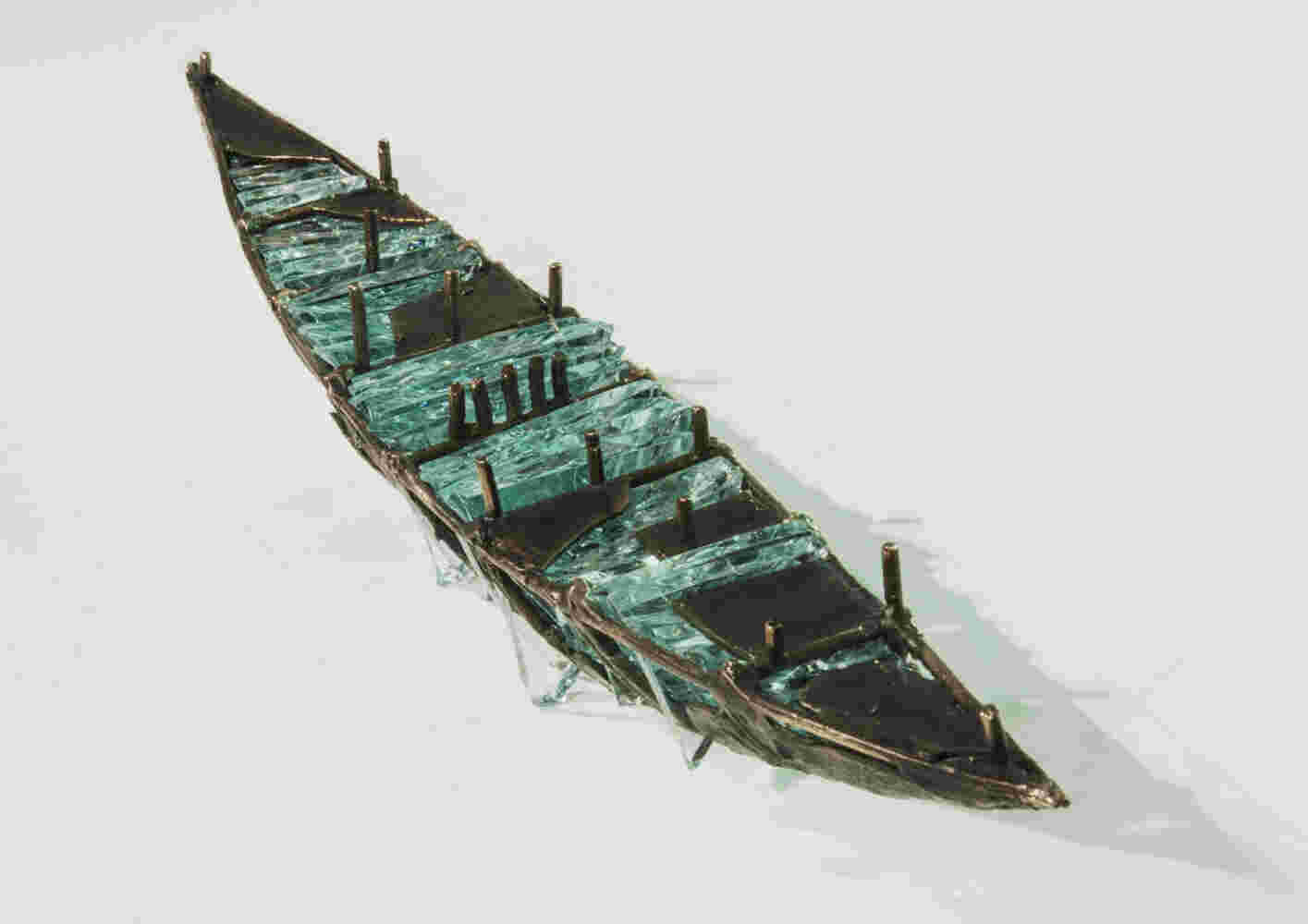 Shipwreck boat sculpture made of hand cut glass and bronze.