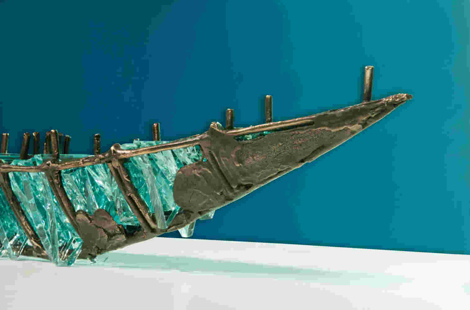 Shipwreck boat sculpture made of hand cut glass and bronze.
