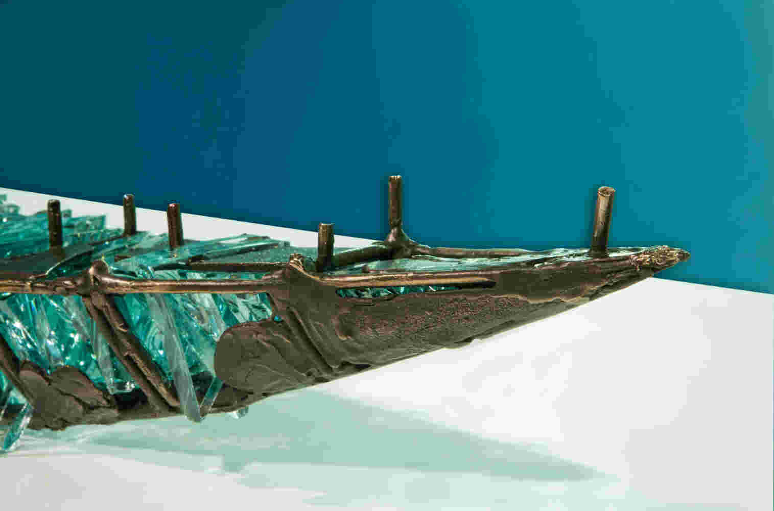 Shipwreck boat sculpture made of hand cut glass and bronze.