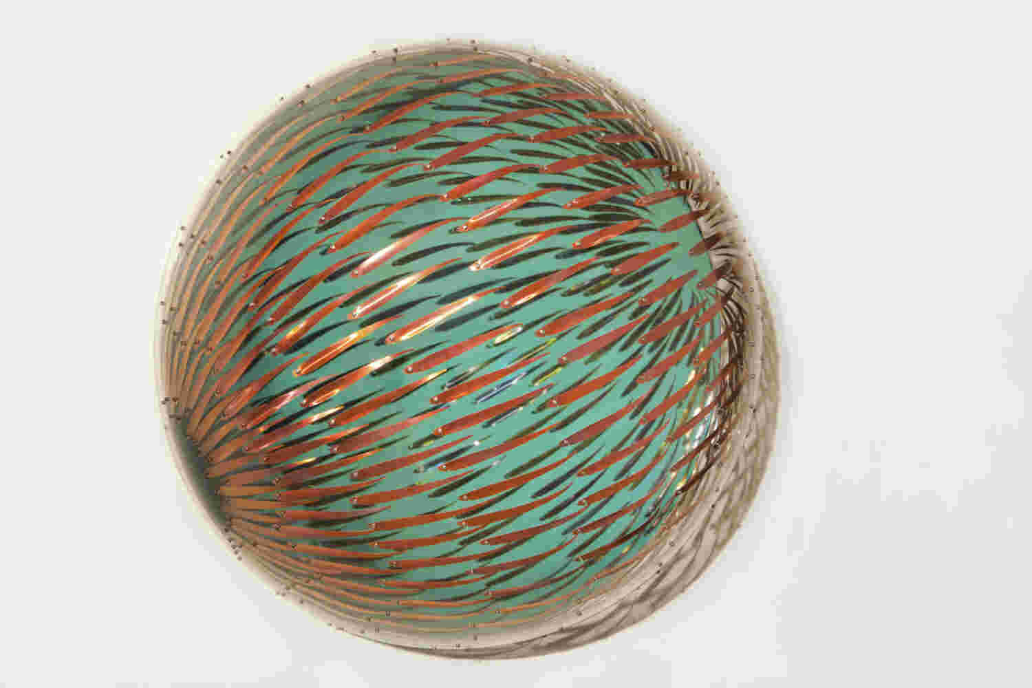 Acrylic hemisphere with metallic fish create a swirling effect that resembles underwater shoals.