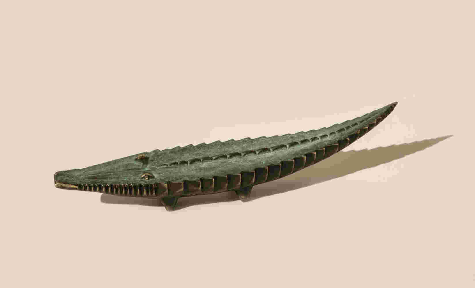 Small sculpture of a cast bronze crocodile finished with a green patina