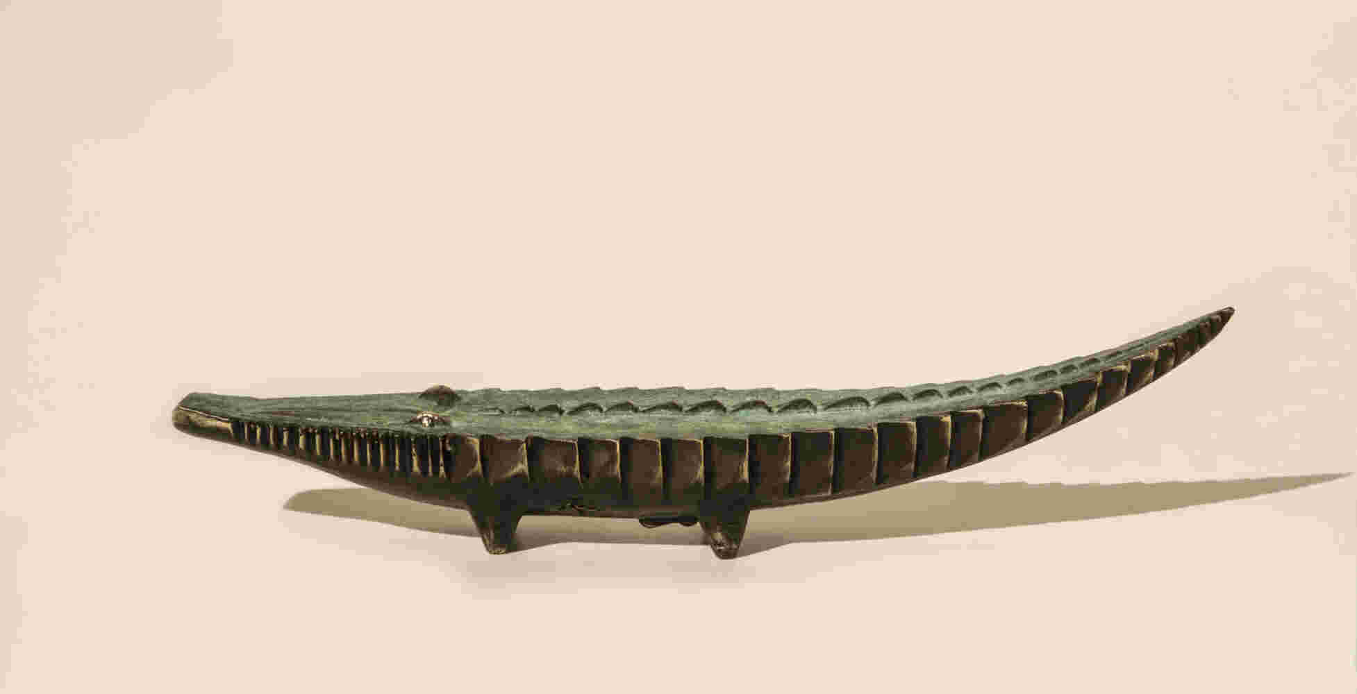 Small sculpture of a cast bronze crocodile finished with a green patina