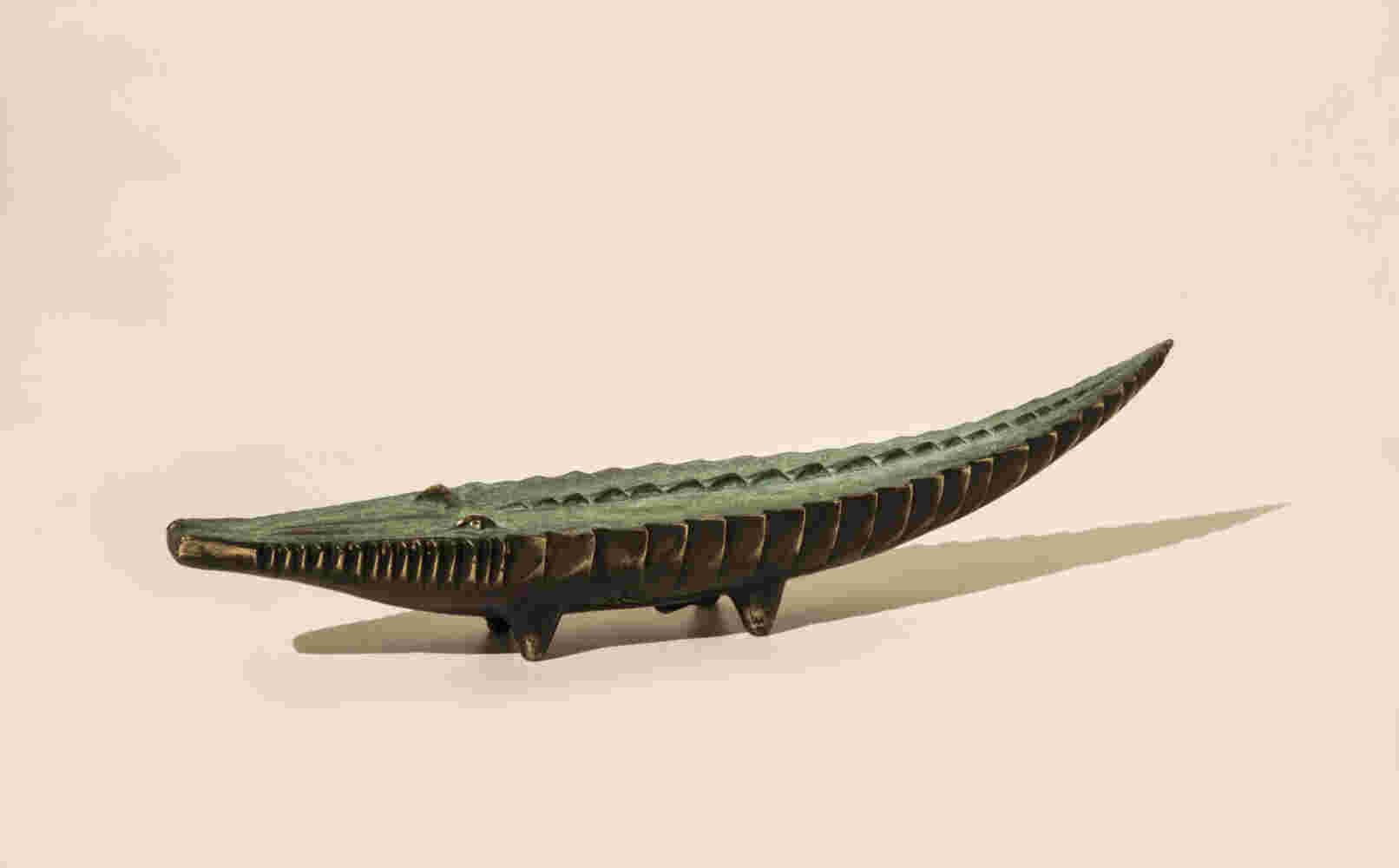 Small sculpture of a cast bronze crocodile finished with a green patina