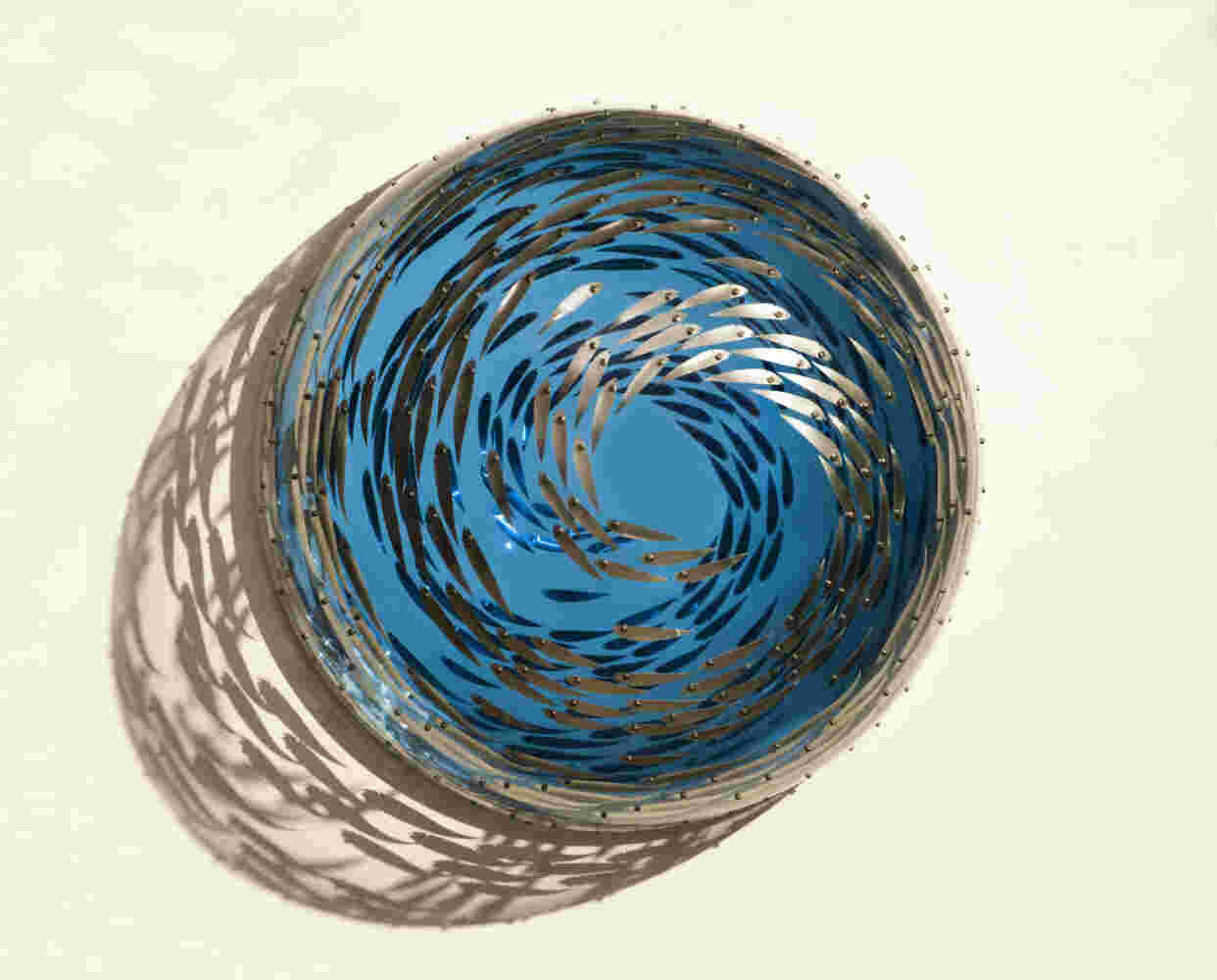 Acrylic hemisphere with metallic fish create a swirling effect that resembles underwater shoals - ⌀70x35cm.