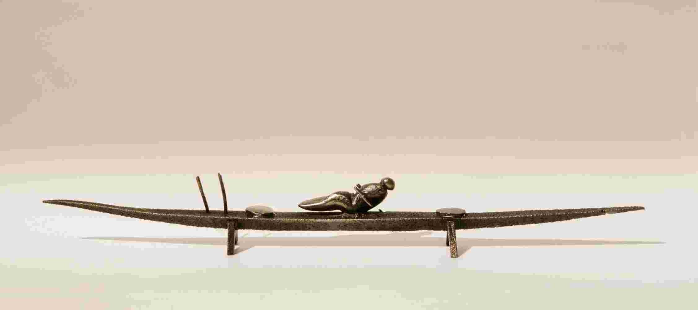 Small boat sculpture made of cast bronze.