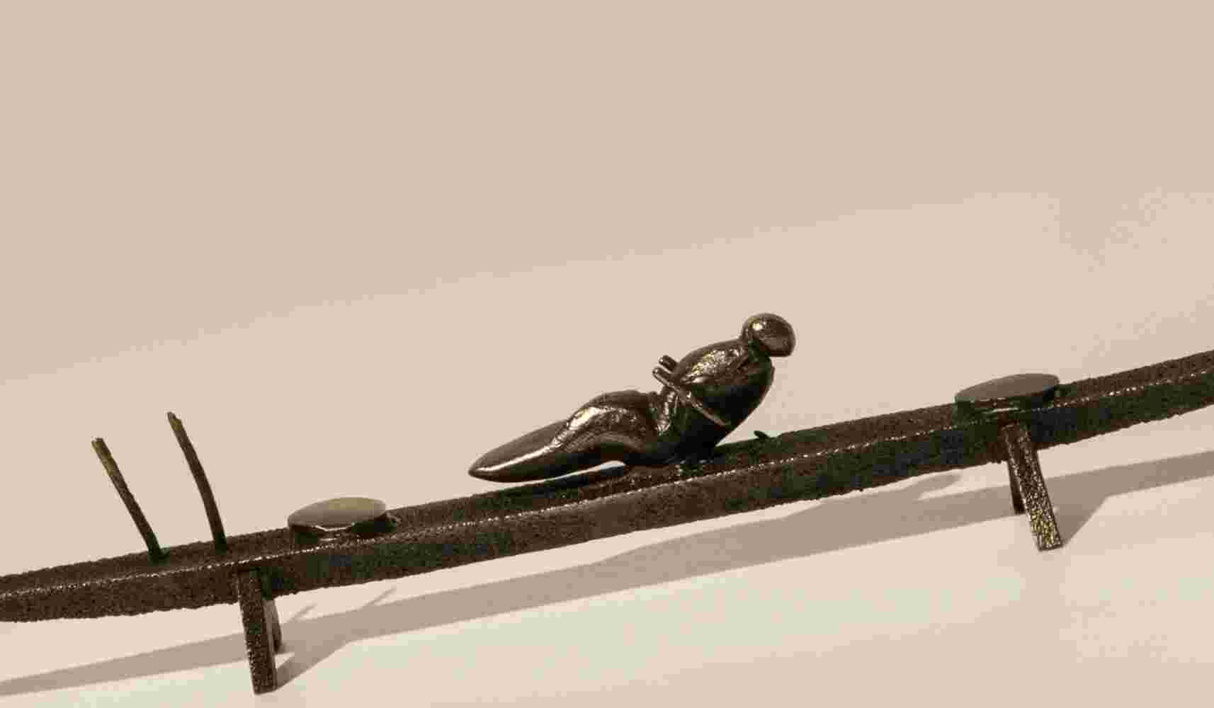 Small boat sculpture made of cast bronze.