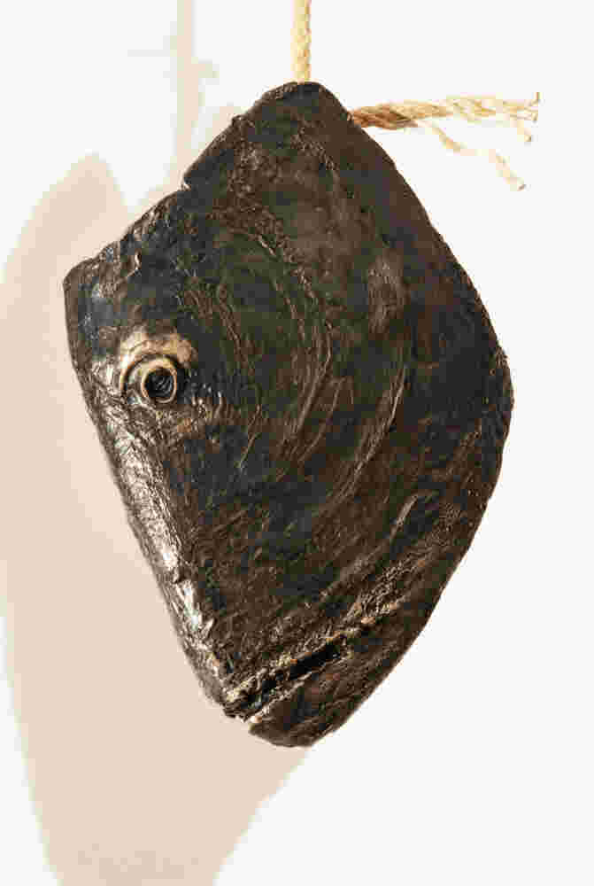 Three cast bronze hanging fish heads installation