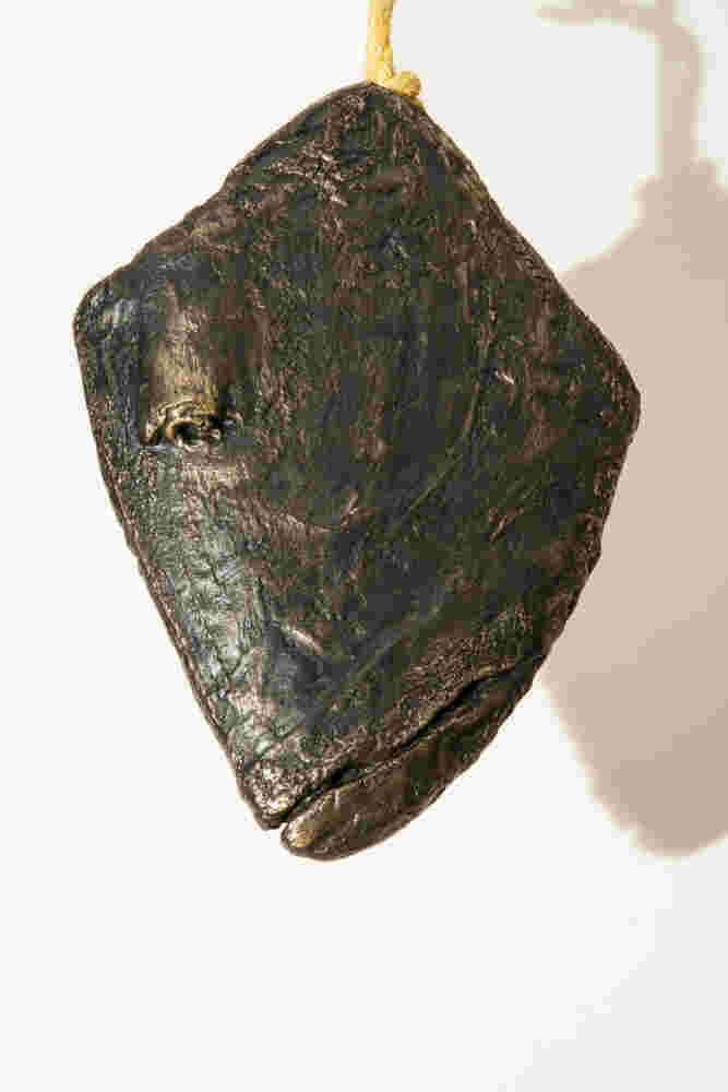 Three cast bronze hanging fish heads installation