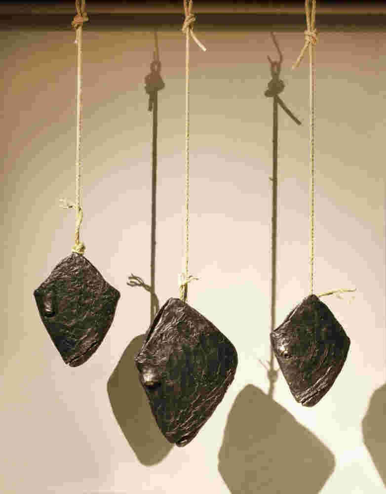 Three cast bronze hanging fish heads installation