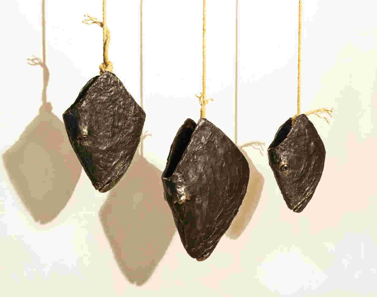 Three cast bronze hanging fish heads installation