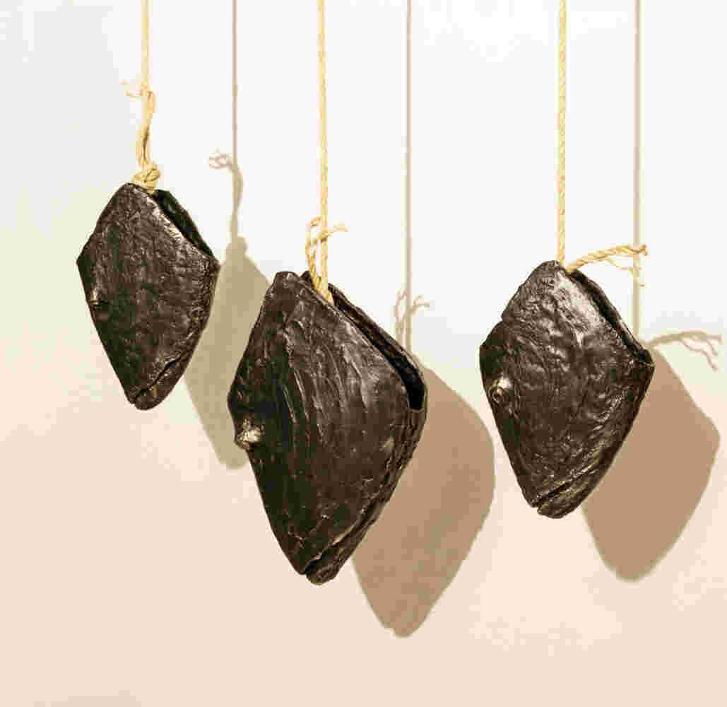 Three cast bronze hanging fish heads installation