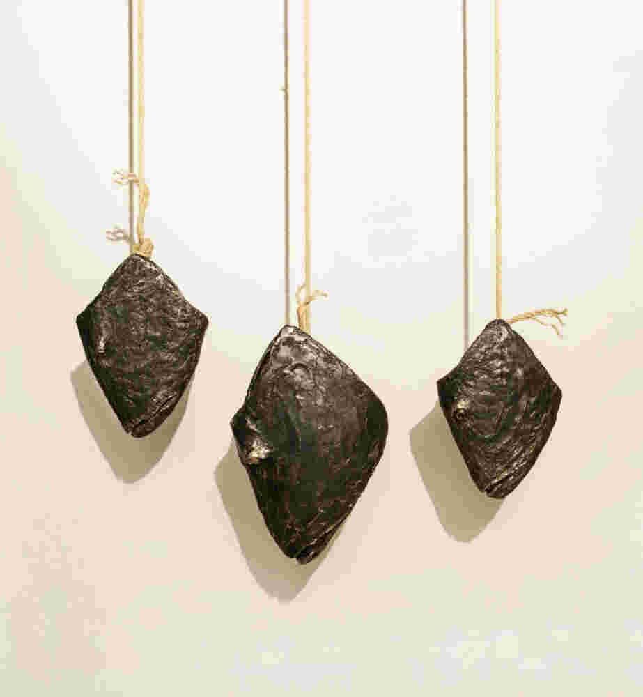 Three cast bronze hanging fish heads installation