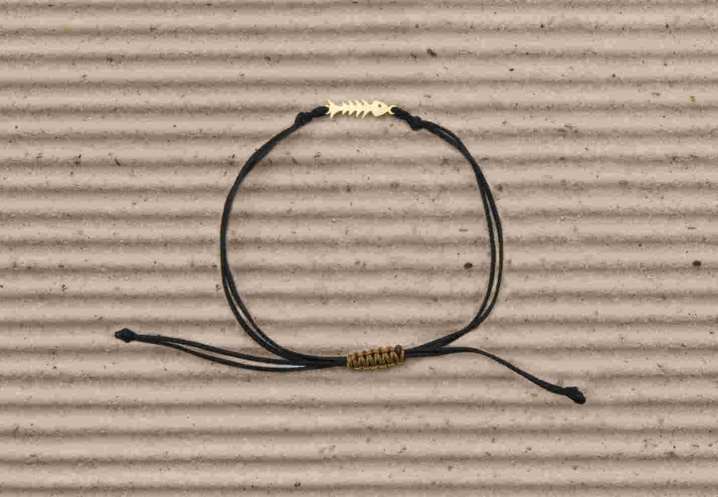 Gold fishbone bracelet with cord