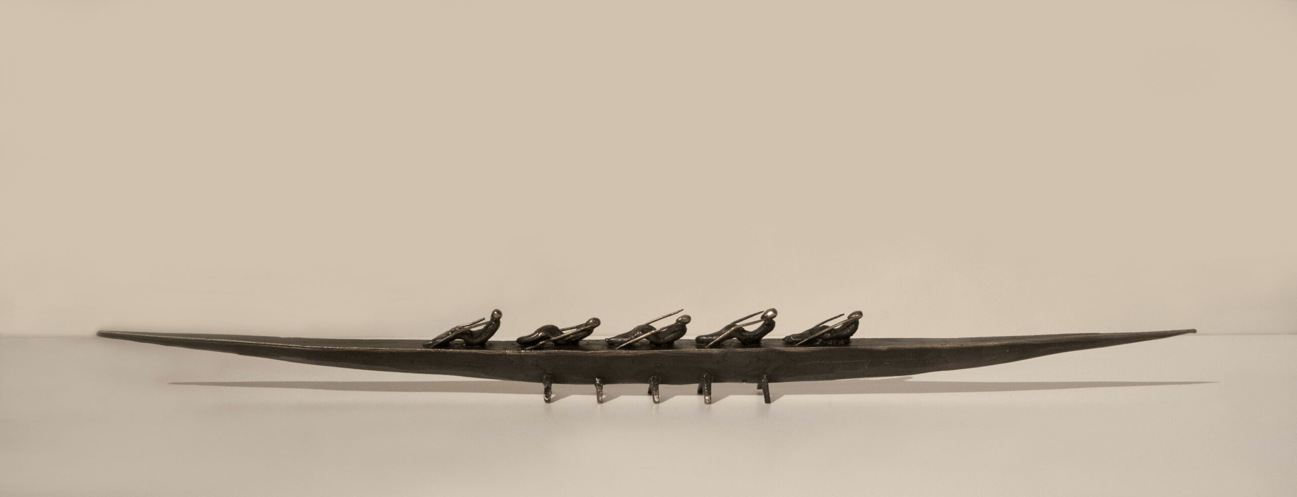 Small boat sculpture made of cast bronze.