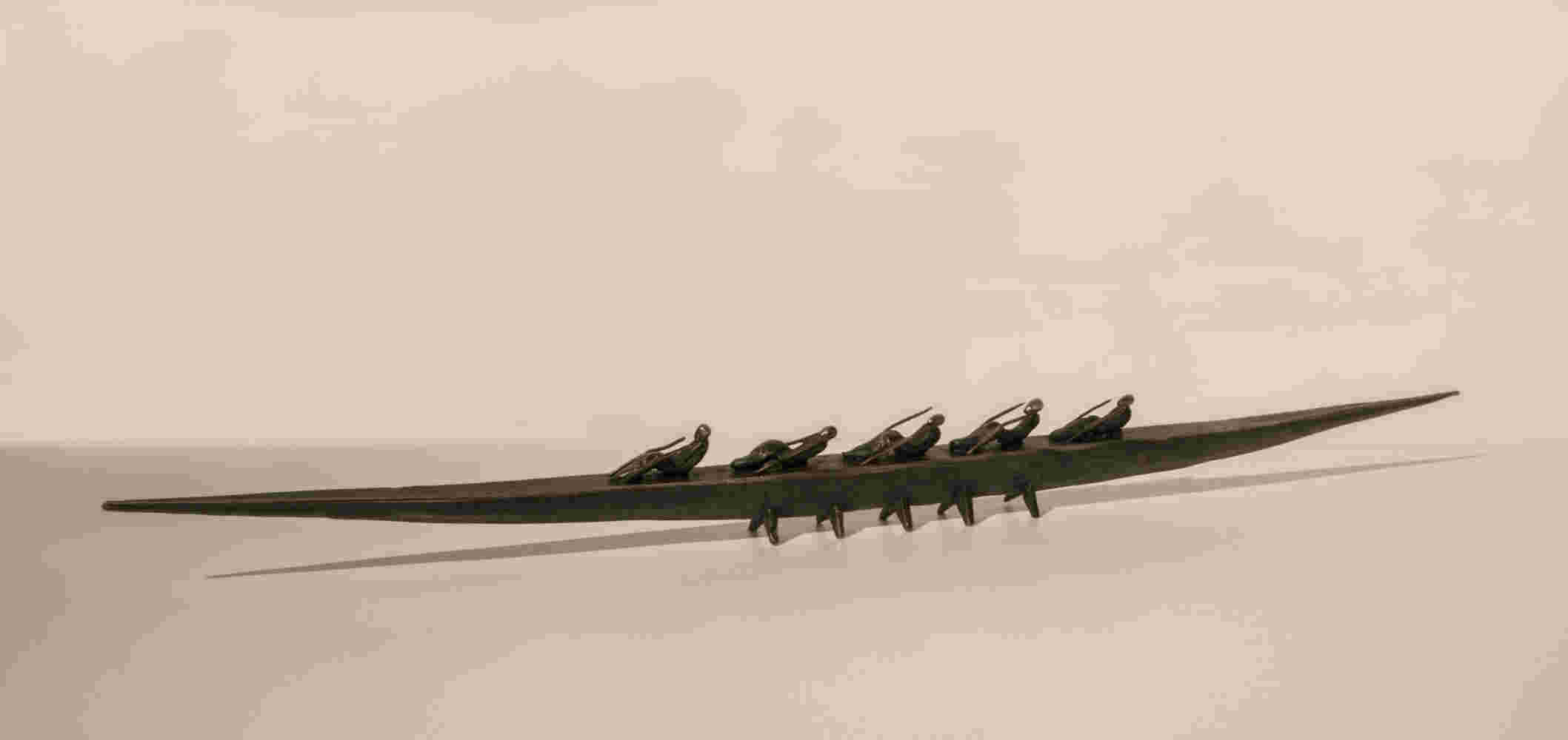 Small boat sculpture made of cast bronze.