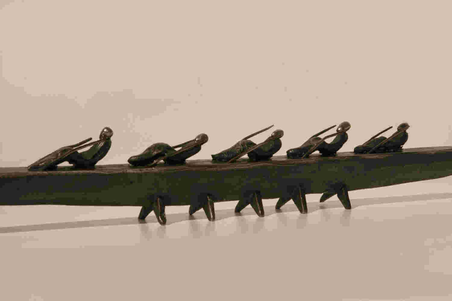 Small boat sculpture made of cast bronze.