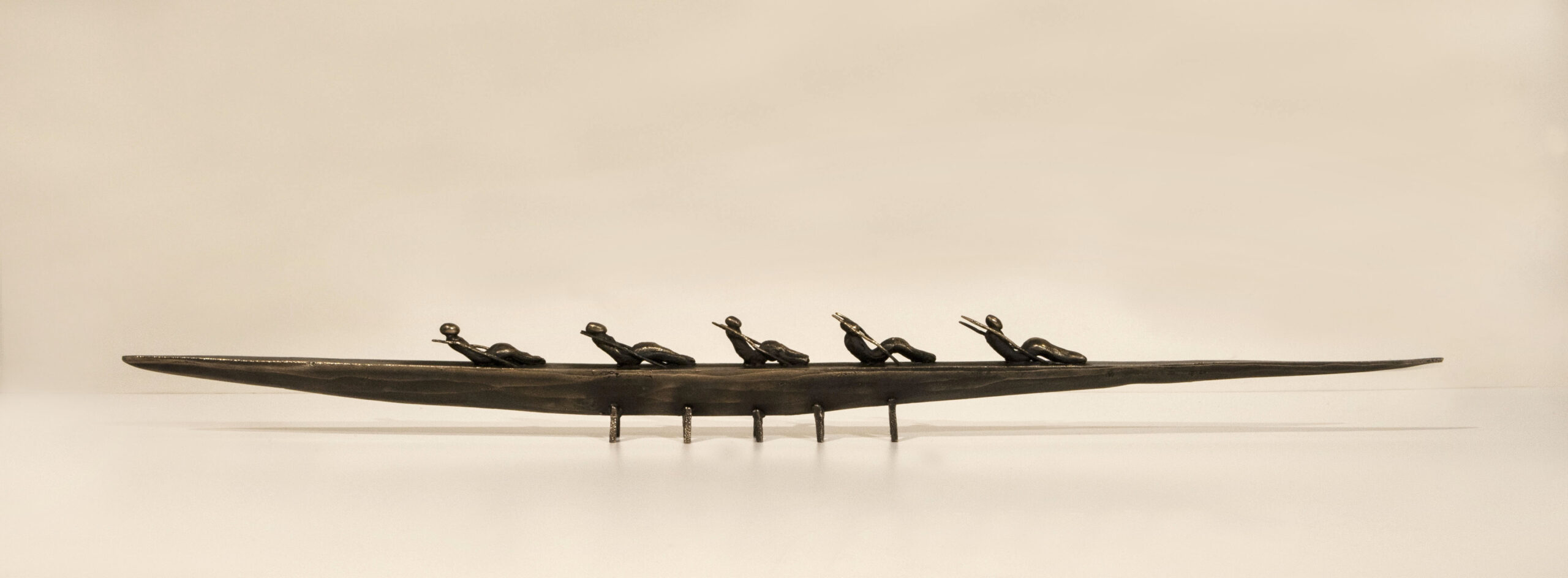 Small boat sculpture made of cast bronze.