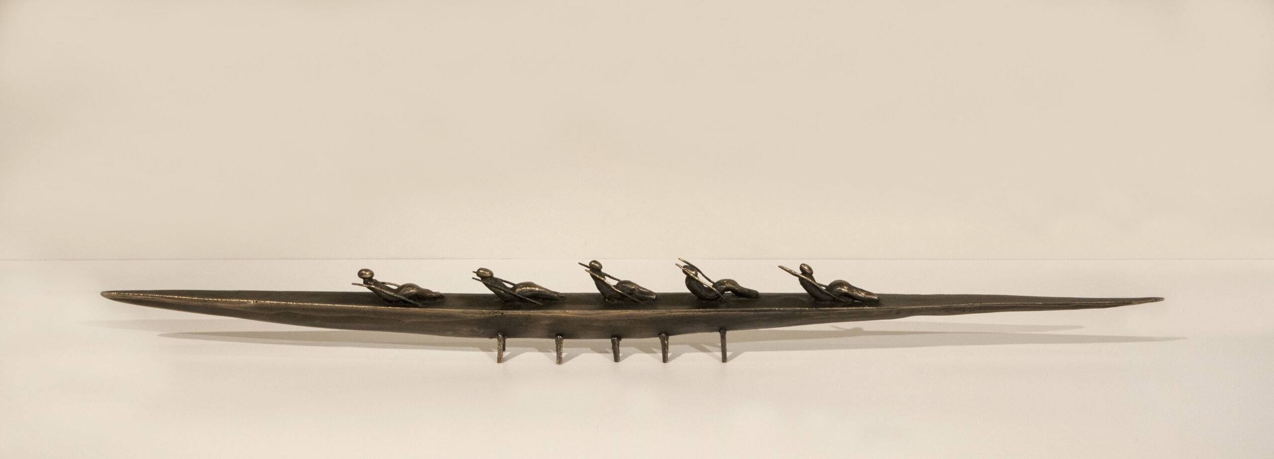 Small boat sculpture made of cast bronze.