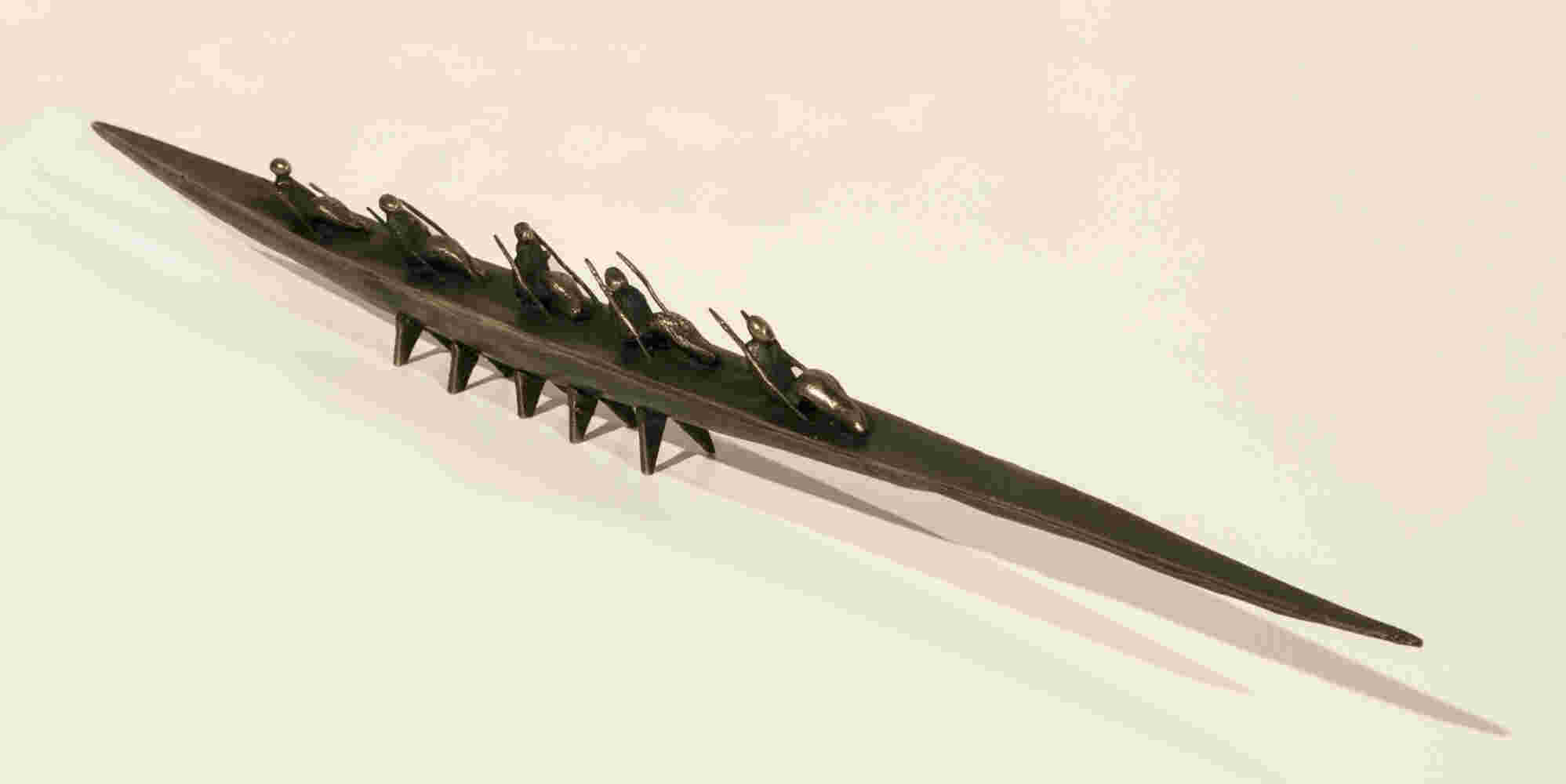 Small boat sculpture made of cast bronze.