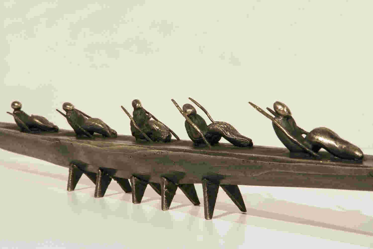 Small boat sculpture made of cast bronze.