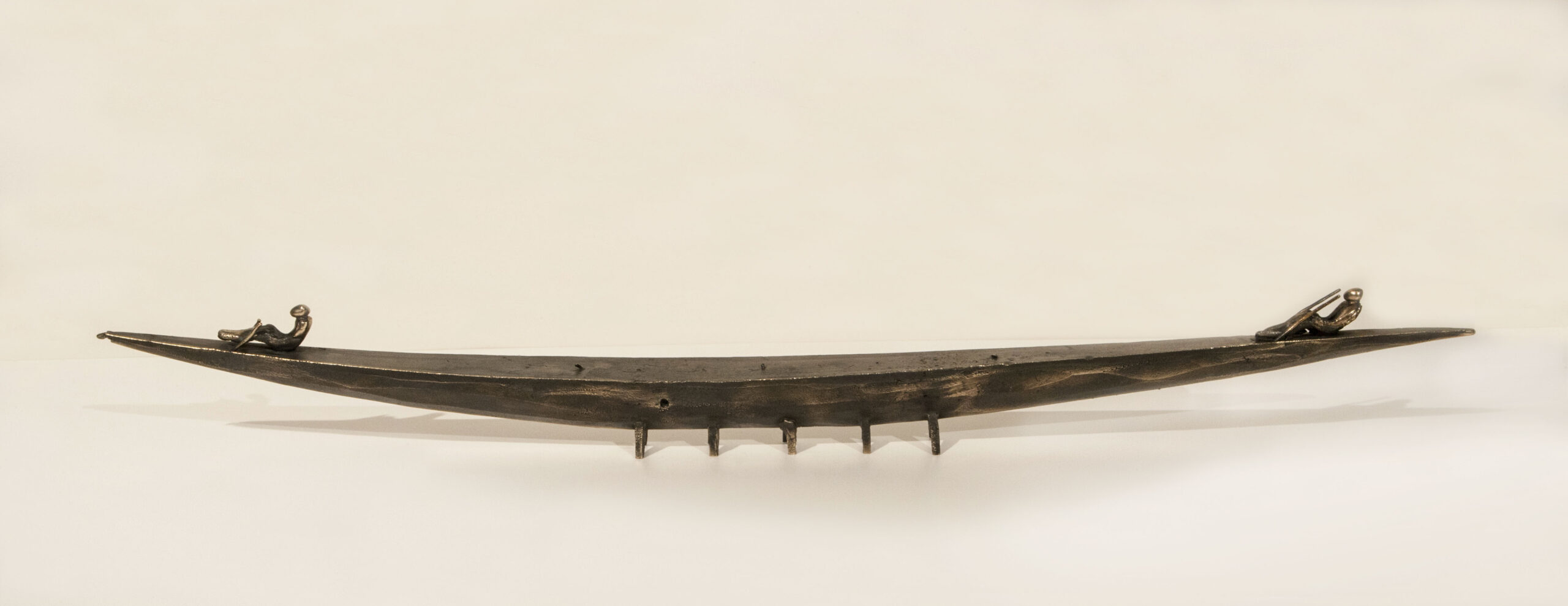 Small boat sculpture made of cast bronze.