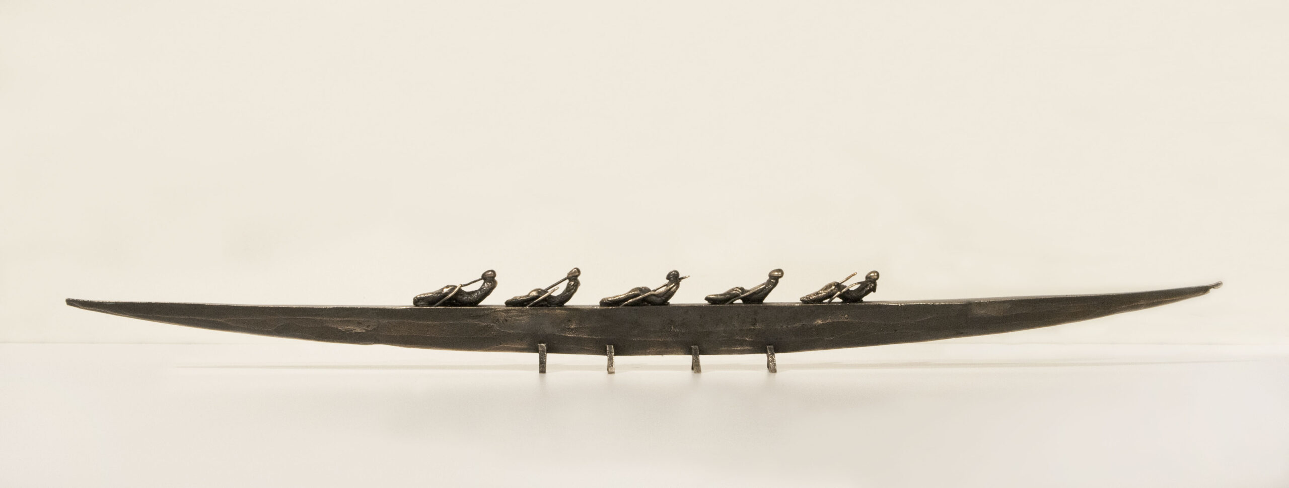 Small boat sculpture made of cast bronze.