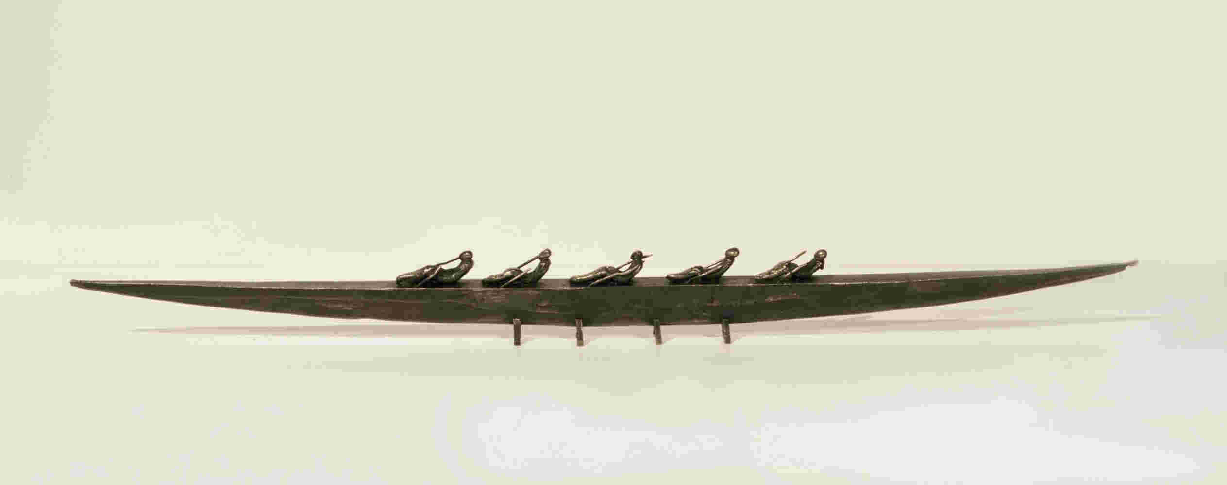 Small boat sculpture made of cast bronze.