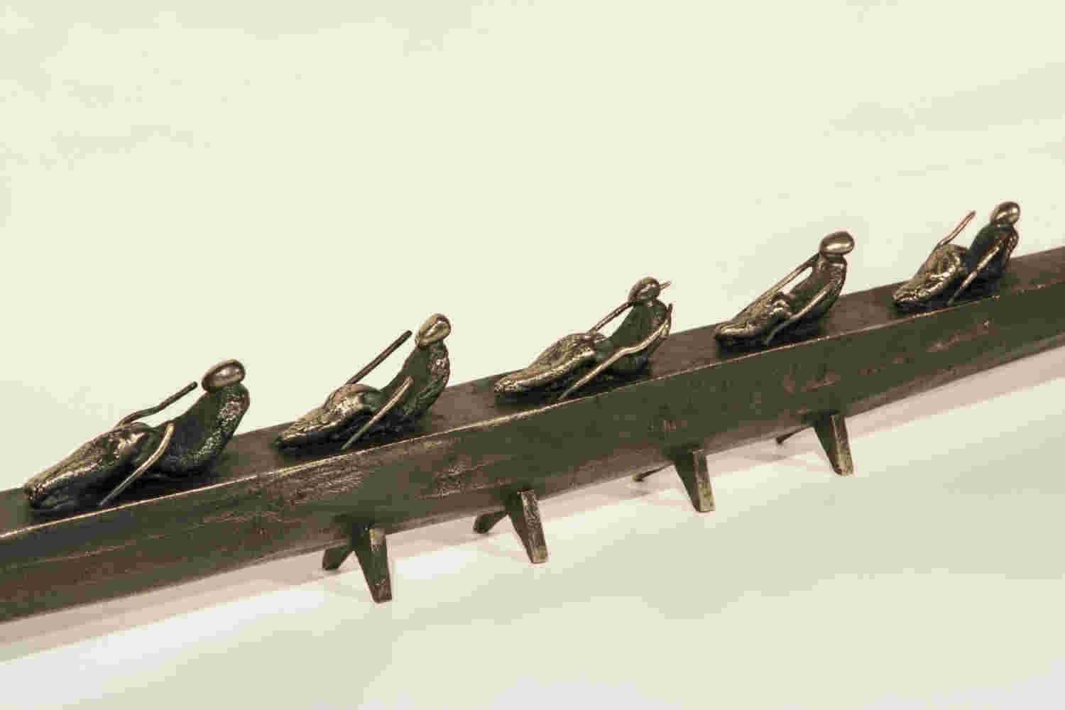 Small boat sculpture made of cast bronze.