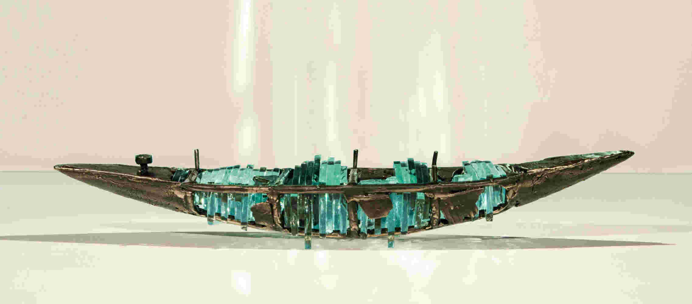 Shipwreck boat sculpture made of hand cut glass and bronze.