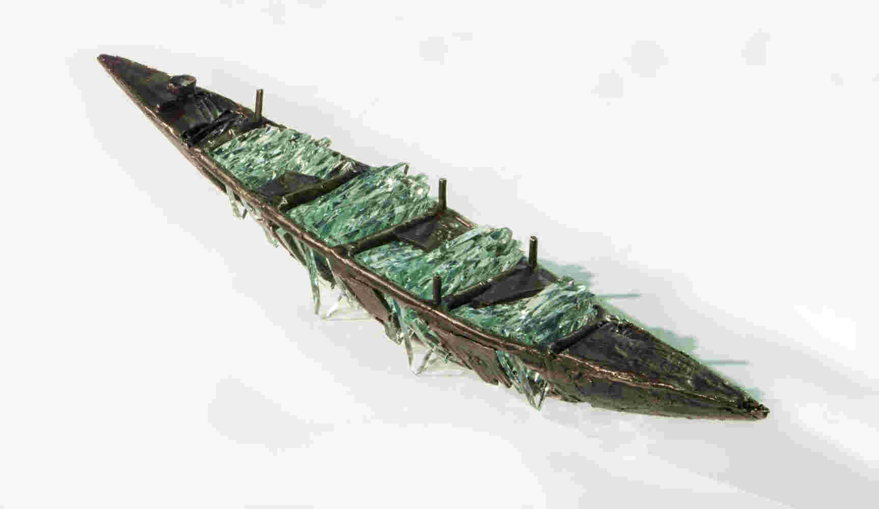 Shipwreck boat sculpture made of hand cut glass and bronze.