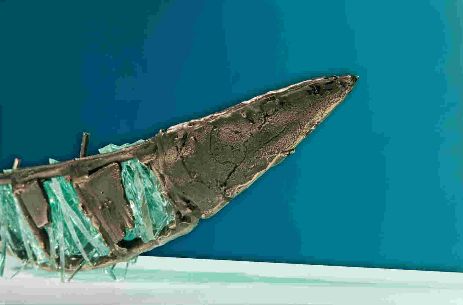 Shipwreck boat sculpture made of hand cut glass and bronze.