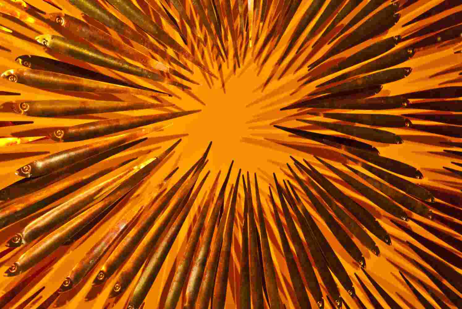 Three-dimensional wall sculpture, school of fish theme, with layers of plexiglass, aluminum frame and exploding copper fish.