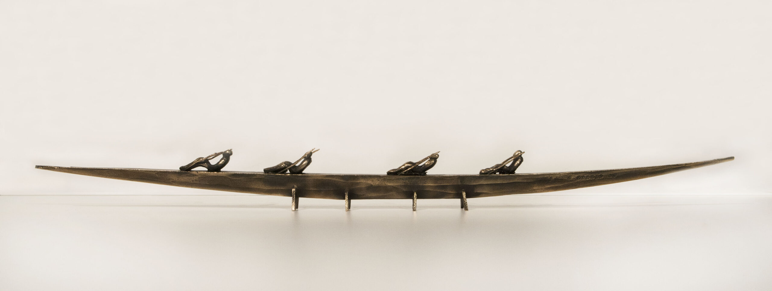 Small boat sculpture made of cast bronze.