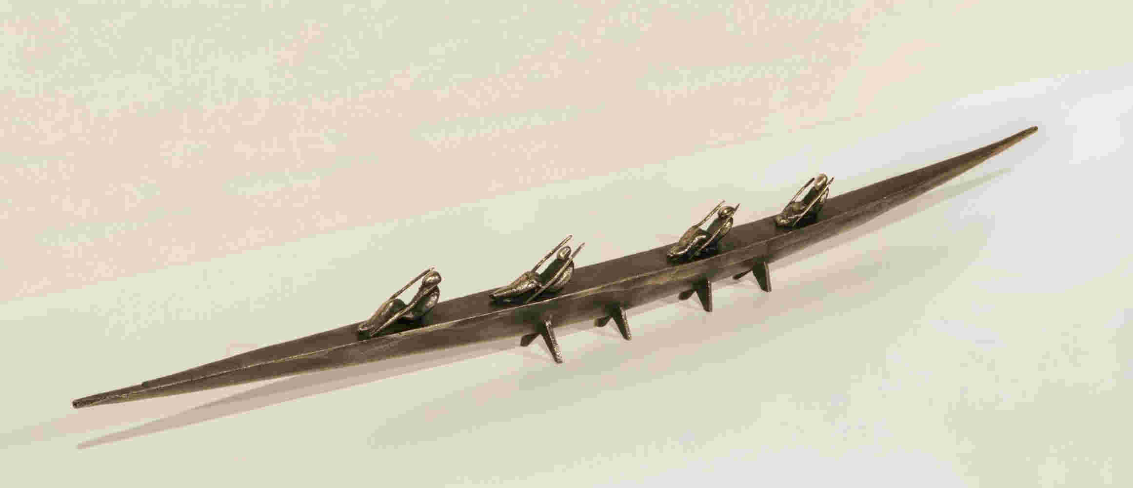 Small boat sculpture made of cast bronze.