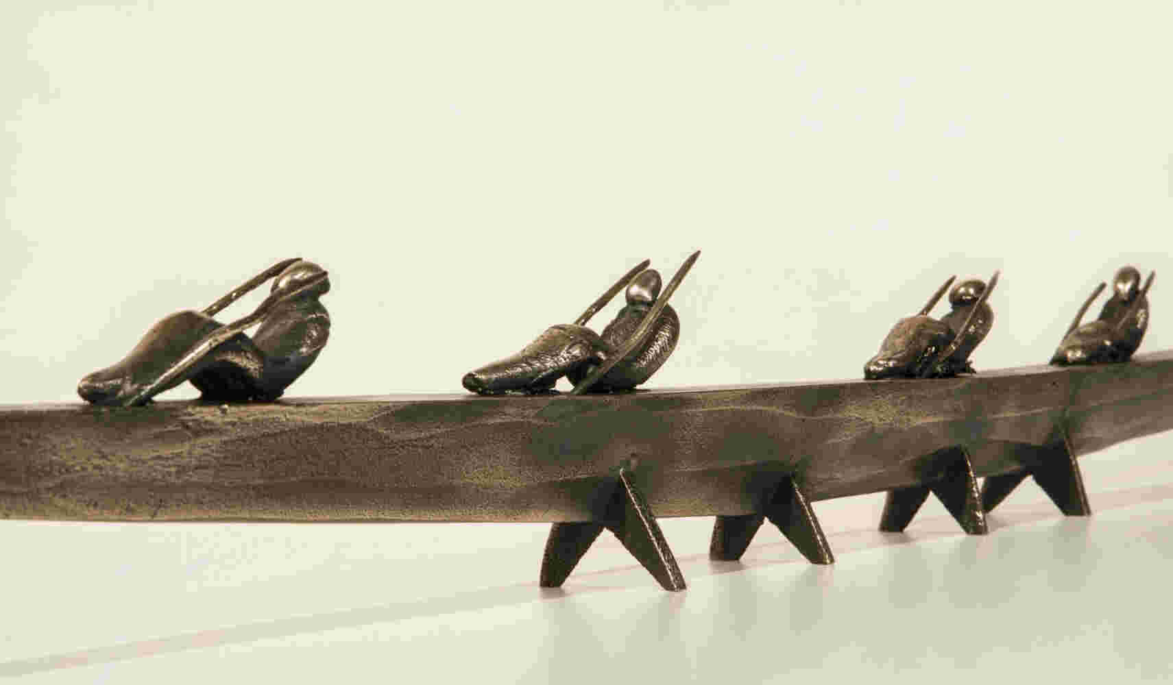 Small boat sculpture made of cast bronze.