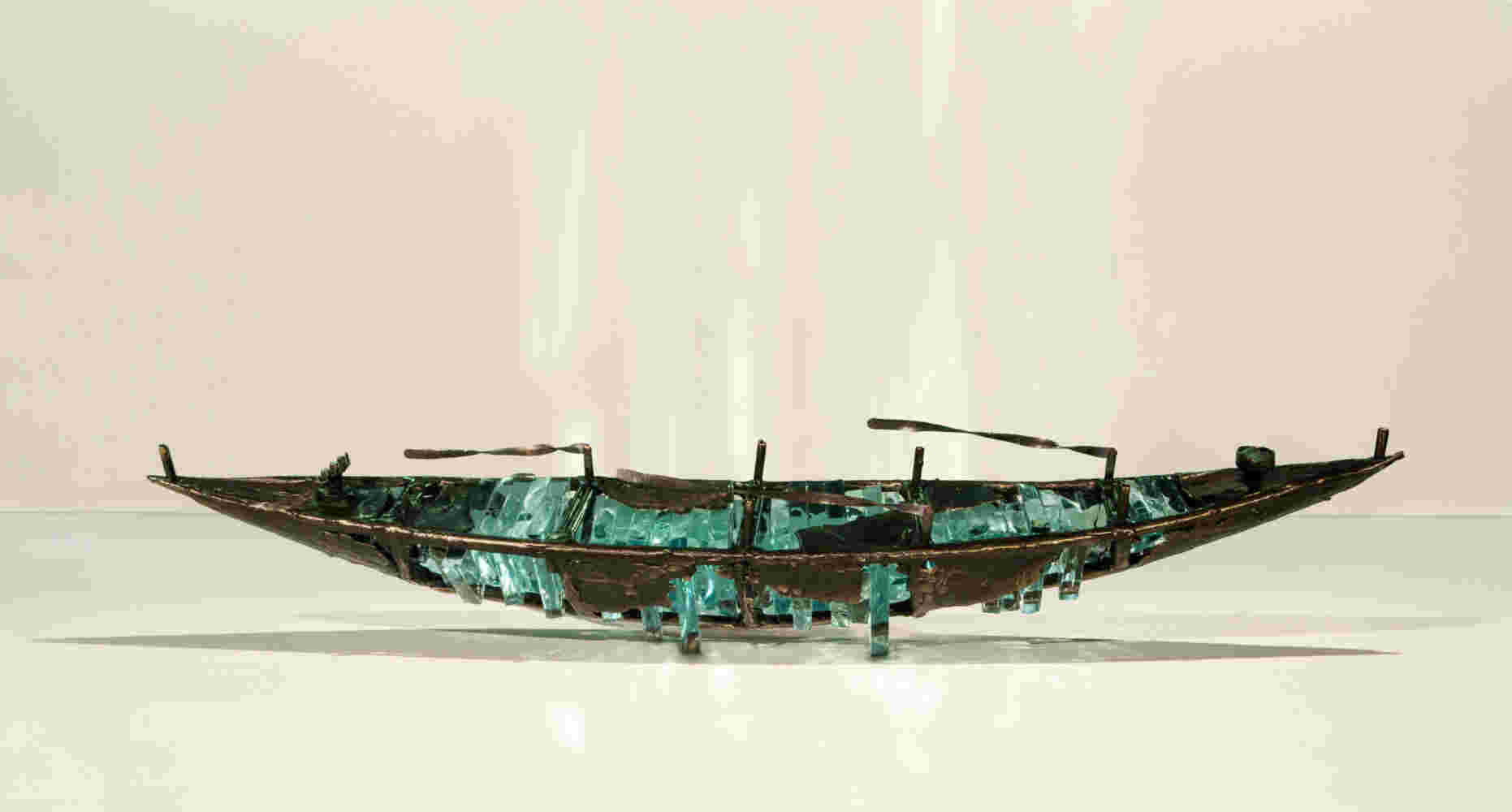 Shipwreck boat sculpture made of hand cut glass and bronze.