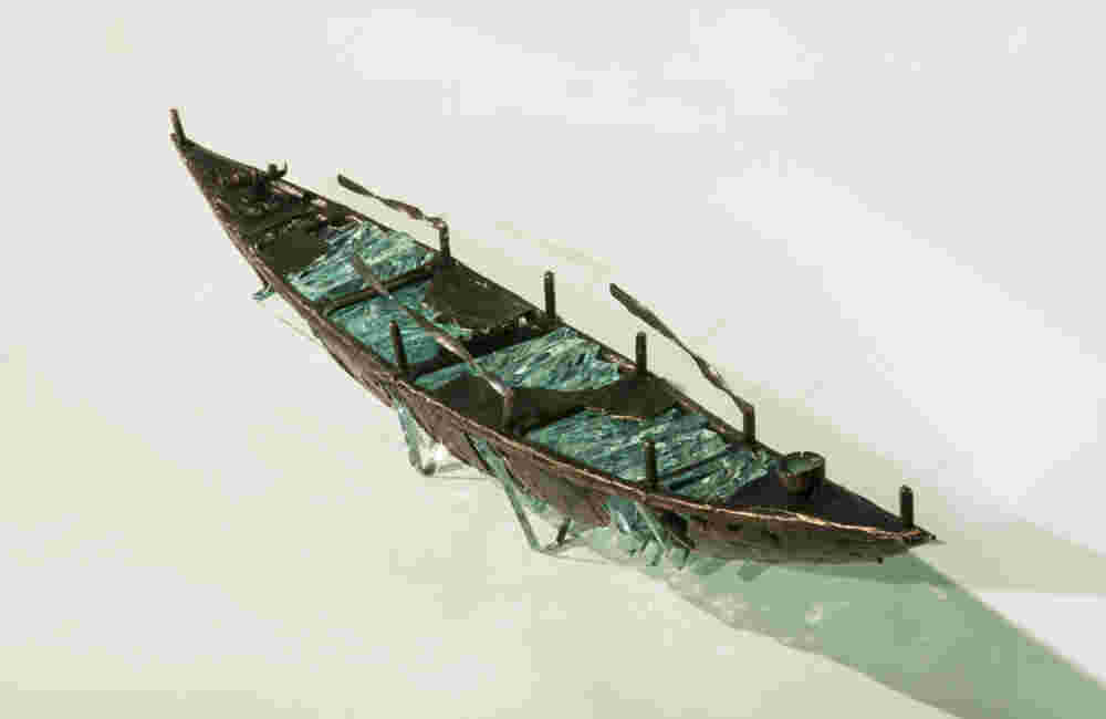 Shipwreck boat sculpture made of hand cut glass and bronze.