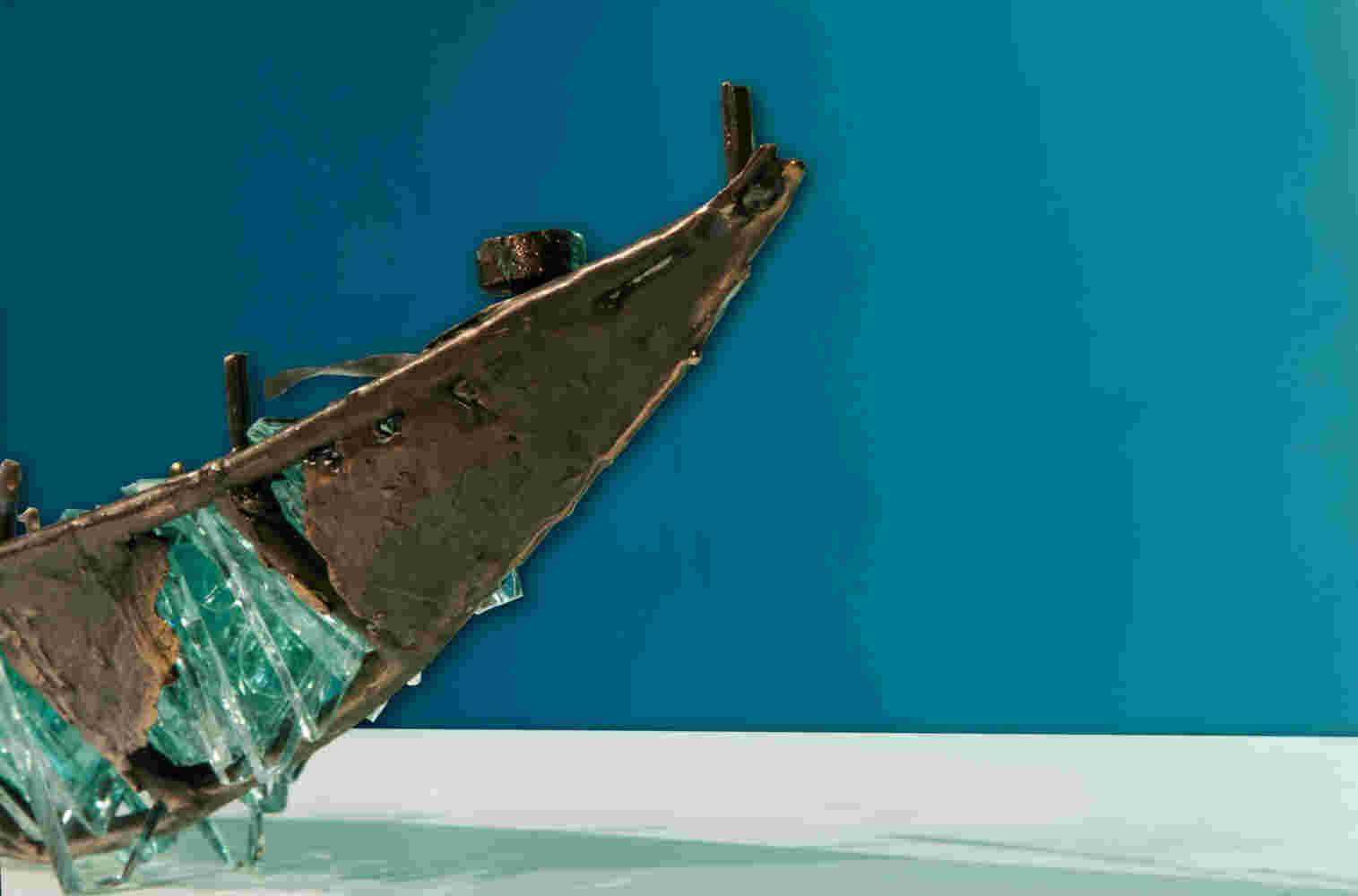 Shipwreck boat sculpture made of hand cut glass and bronze.