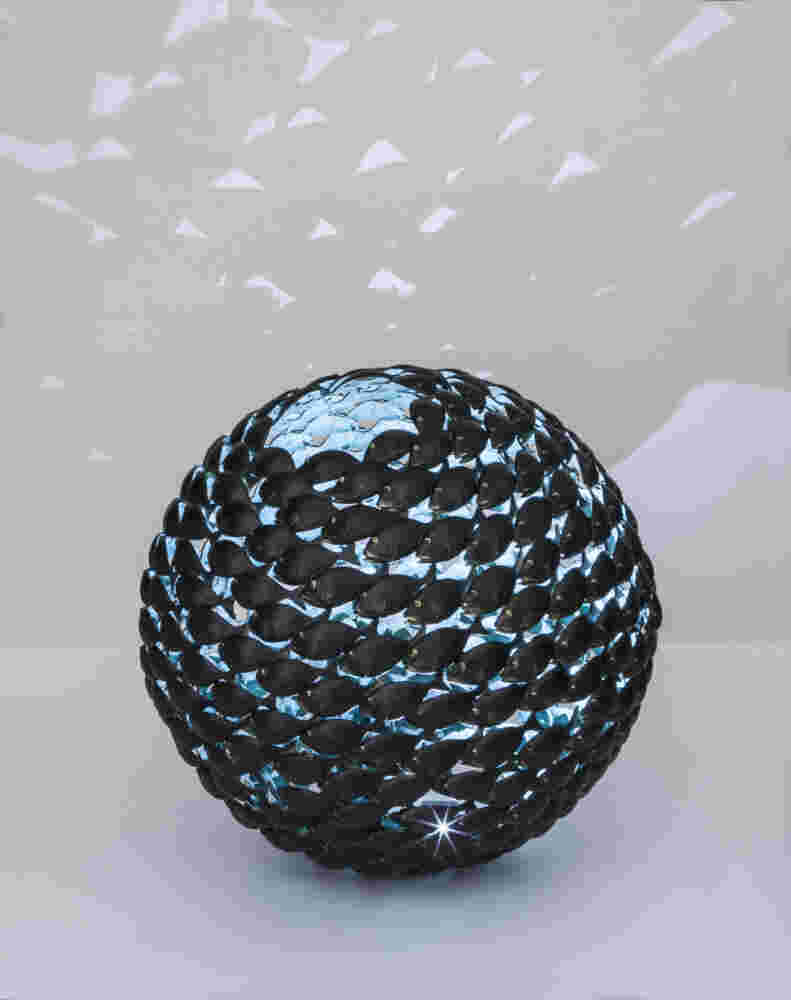 Bronze fish shoal ball with a green interior made of cast bronze