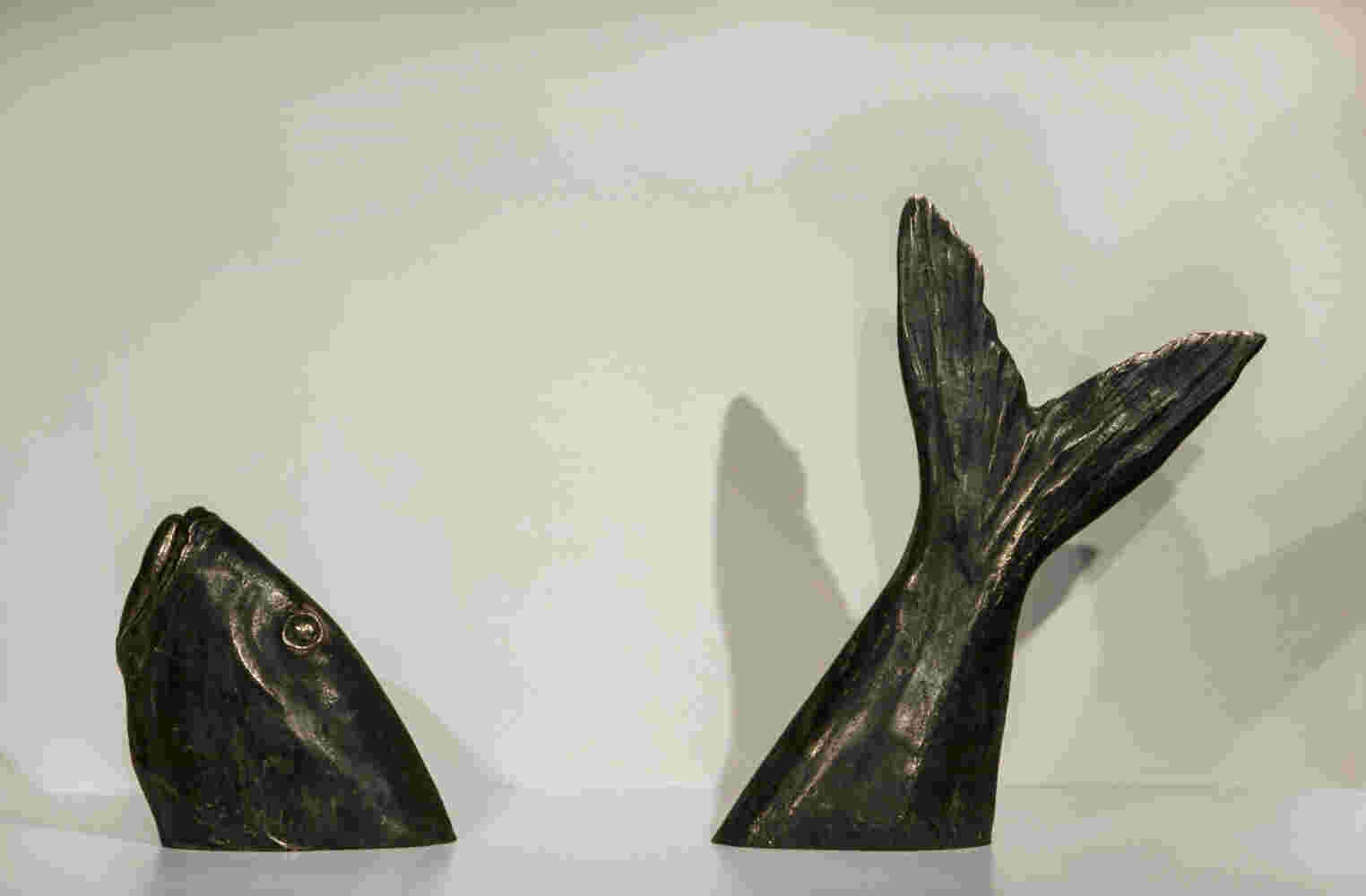 Surrealistic bronze sculpture of a diving fish