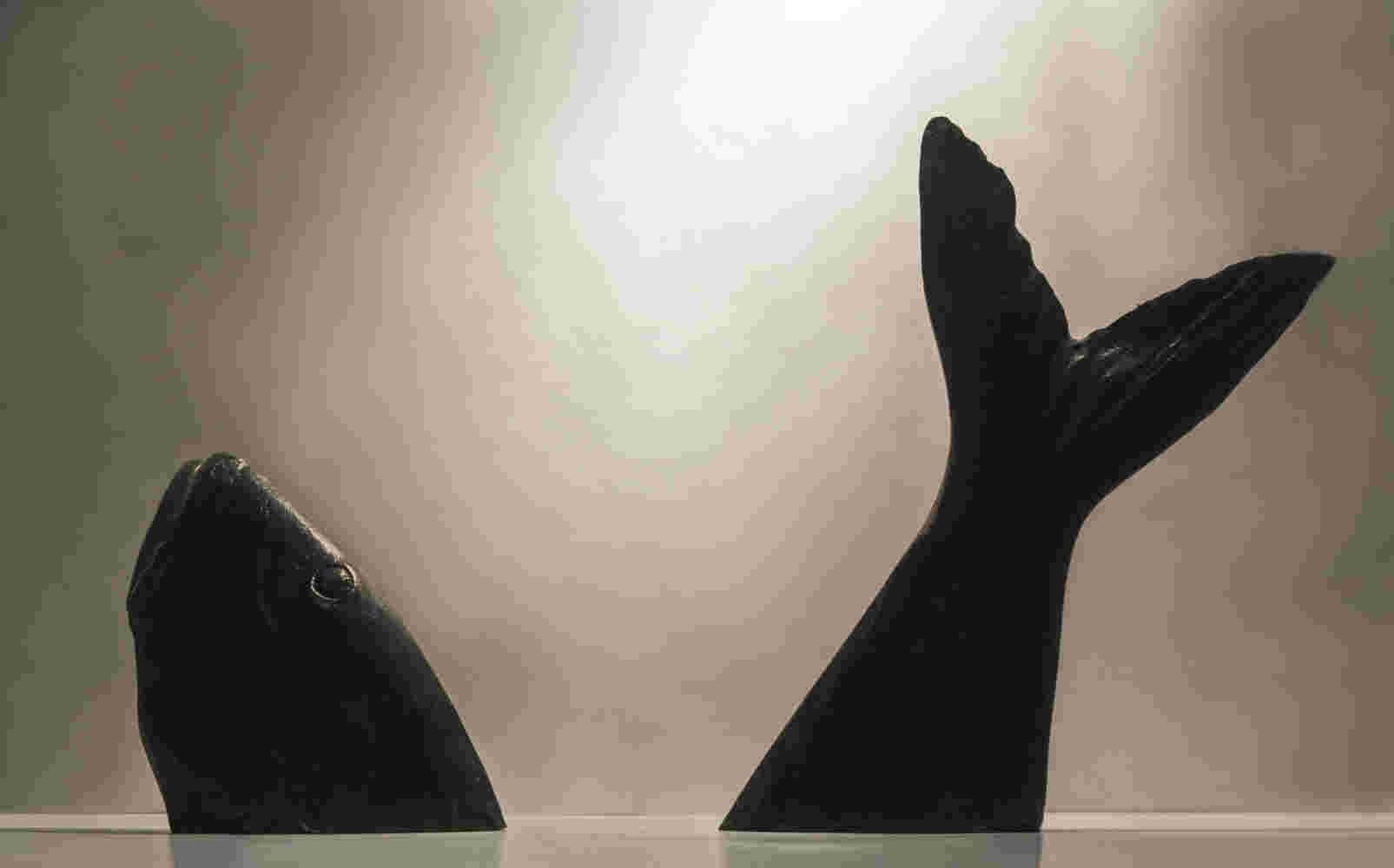 Surrealistic bronze sculpture of a diving fish